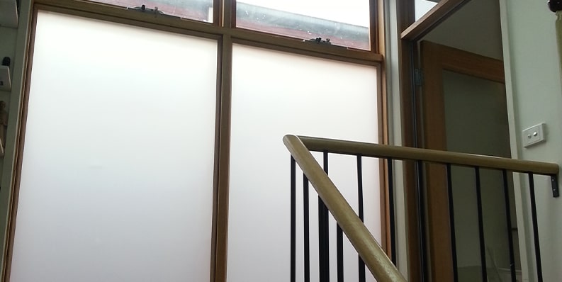 Stairwell flooded with diffused natural light after ecoGlaze secondary glazing installation.